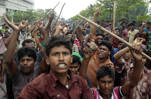 Dhaka, Bangladesh, April 27, 2013. Garment workers block a road during a protest after the collapse of an eight-story building that housed five garment factories.  