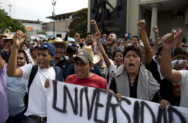 Demonstrators chant slogans during a march to protest the disappearance of 43 students from the Isidro Burgos rural teachers college in Chilpancingo, Mexico, October 8. AP photo.