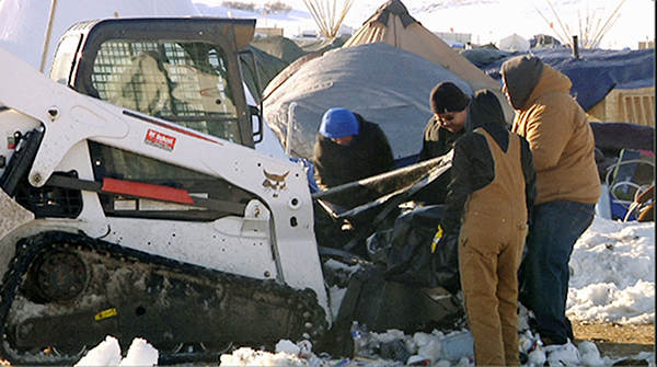 Cleanup at the main camp of Water Resisters in North Dakota in preparation for possible floods from melting snow.