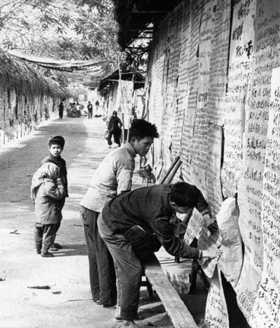 Putting up "Big Character Posters" on a wall during the Great Proletarian Cultural Revolution in China.