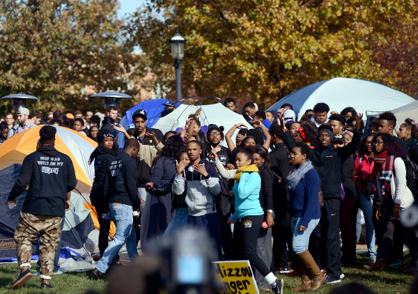 University of Missouri students celebrate as Jonathan Butler, center, waving, ended his hunger strike Monday, Nov. 9, 2015, after University of Missouri System President Tim Wolfe officially resigned.