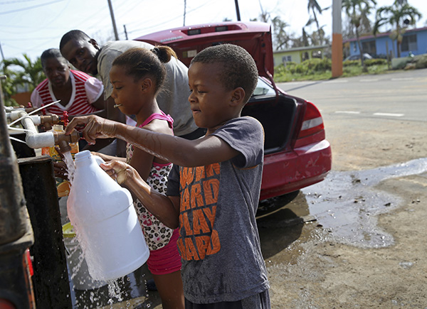 Children getting water at a distribution point.