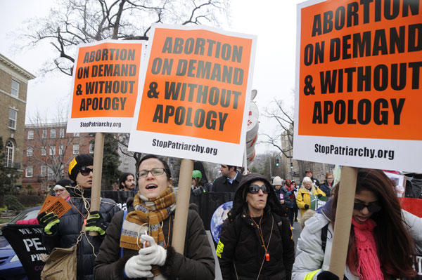 Women from Stop Patriarchy and Pornography Week of Action joined the protest of war crimes at the Obama Inauguration