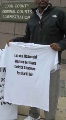 Holding t-shirt at Iggy and Alfredo's hearing