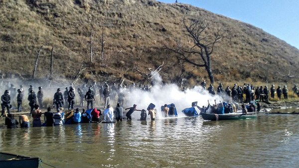 Up to 100 riot police attack people who reached Turtle Island. Photo: Special to revcom.us.