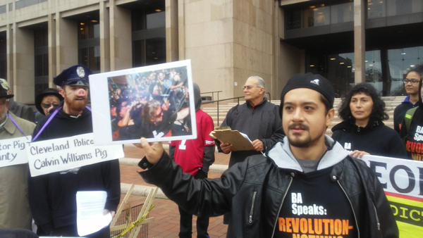 Noche Diaz questions a man dressed as a pig named "Chief Pig Calvin William" in front of the Justice Center.