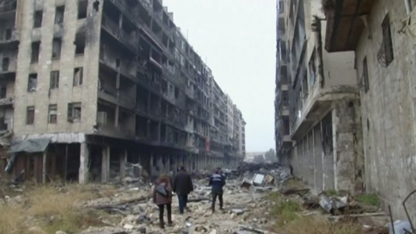 People walk amidst the rubble caused by relentless bombing in Aleppo, Syria on December 13. (AP photo)