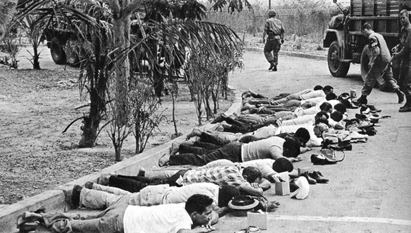 A U.S. checkpoint and search of civilians in Santo Domingo during U.S. assault on the Dominican Republic, 1965.