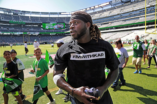 Miami Dolphin player in #IMWITHKAP T-shirt.