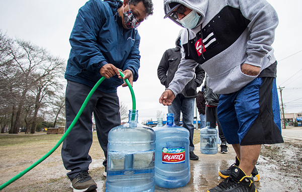 Water pipes burst; people fill water bottles