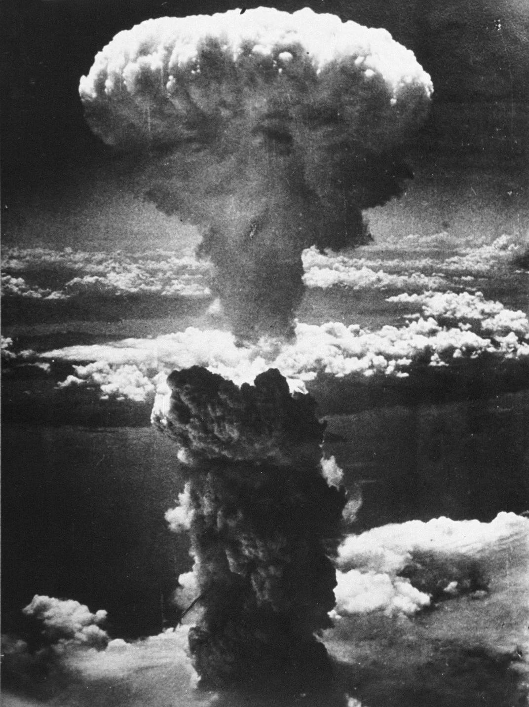 A dense column of smoke rises more than 60,000 feet into the air over Nagasaki.