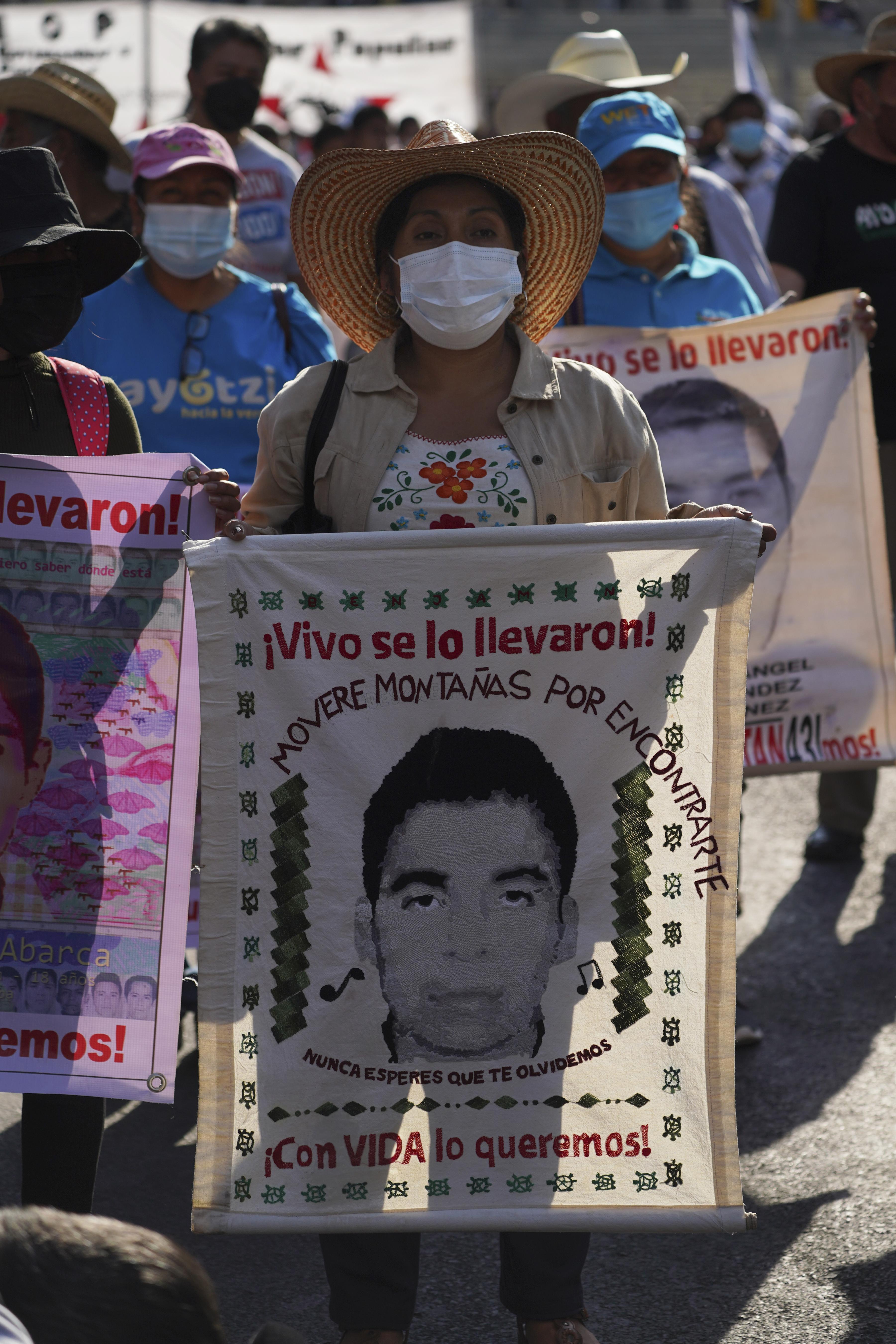 Family members and friends march seeking justice for the missing 43 Ayotzinapa students in Mexico City, March 26, 2022.