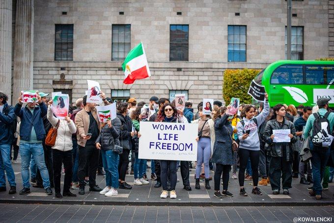 Dublin, Ireland, woman carrying poster that says Woman Life Freedom