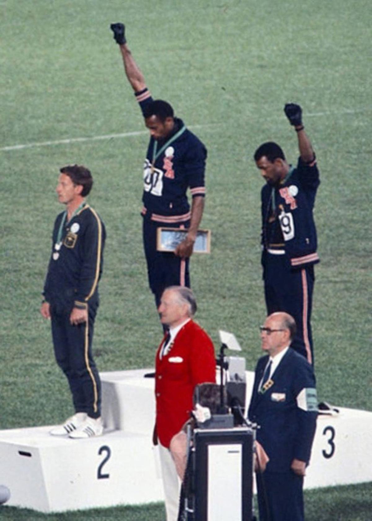 1968 at the olympics, John Carlos, Tommie Smith with fists in the air, and Peter Norman.