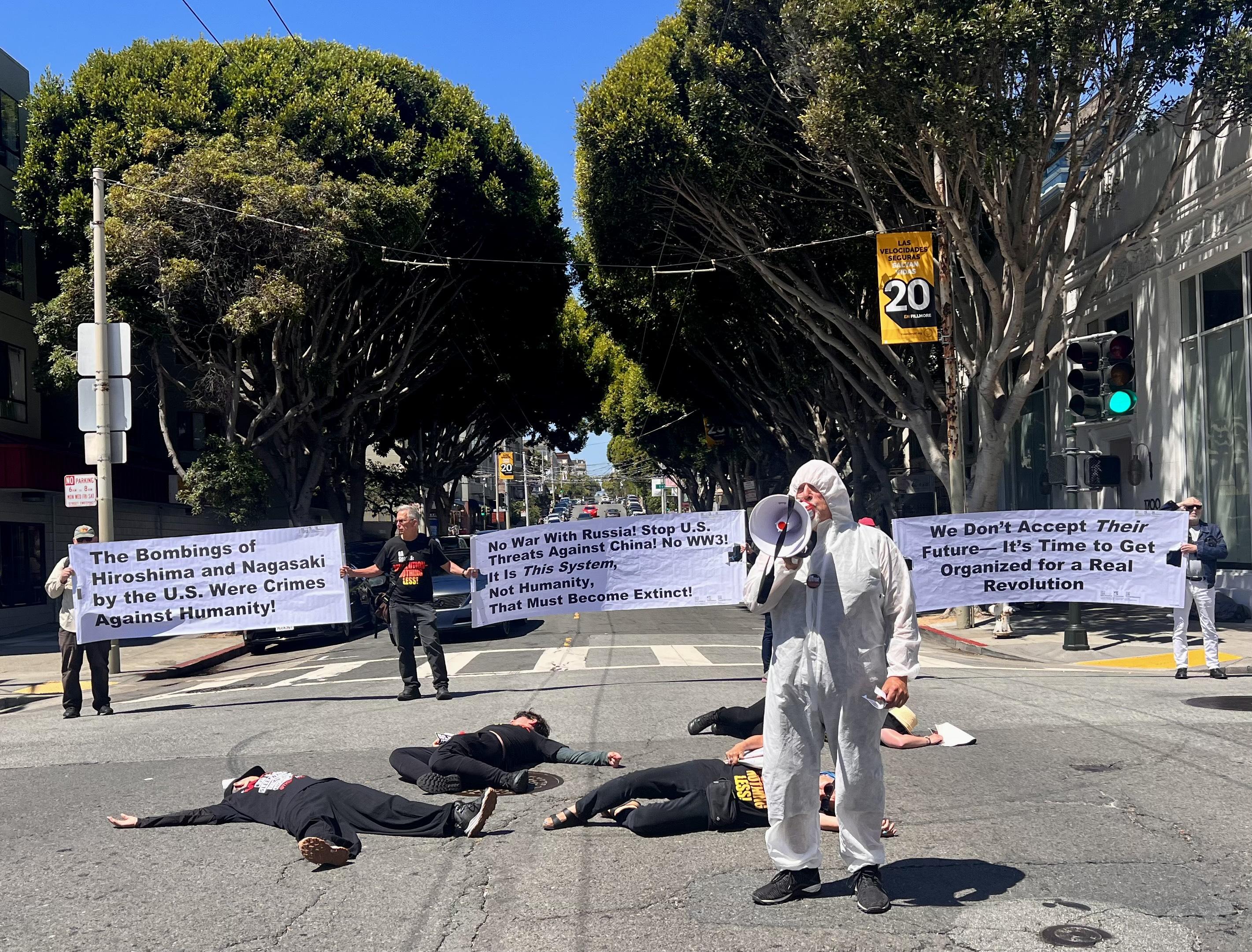 People lying on the ground in a die-in on Hiroshima Day, San Francisco.