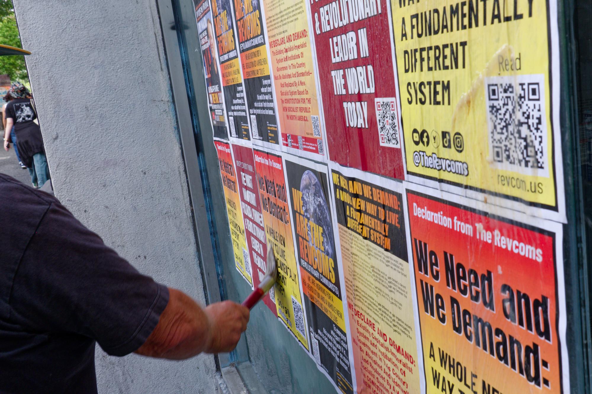 Postering a wall in Berkeley