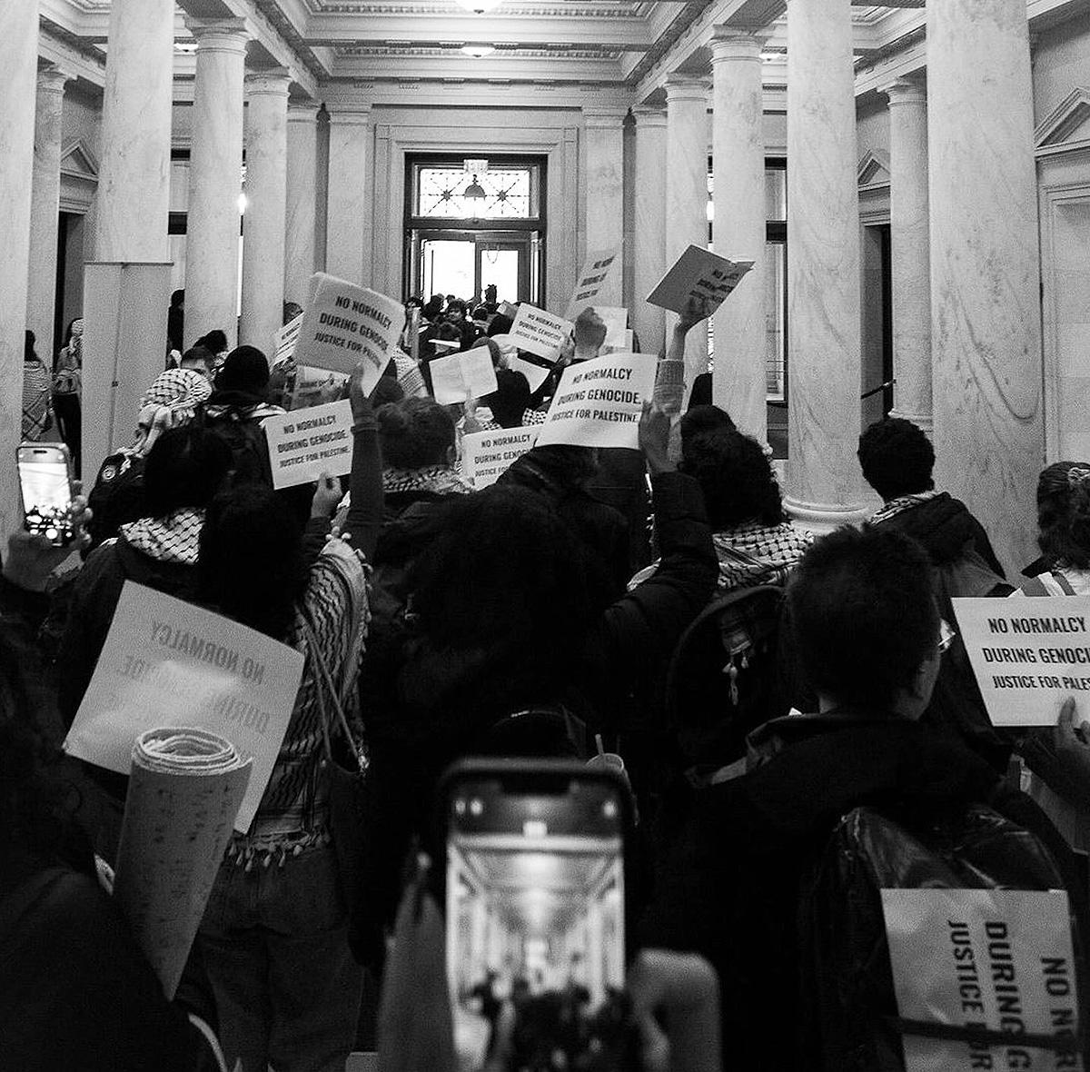 Students at Harvard stage a silent pro-Palestine protest in the library.