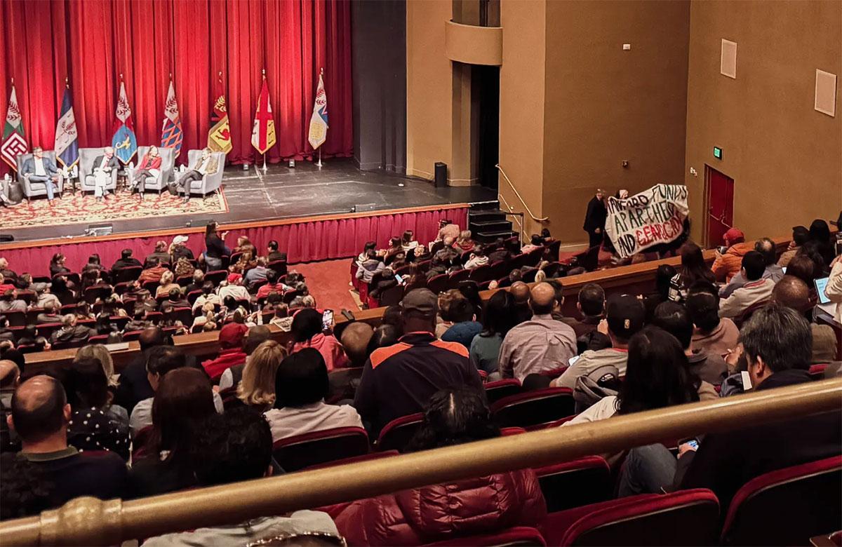 February 2024, Stanford University students unfurl a banner reading “Stanford funds apartheid and genocide” during a parents' weekend event. 