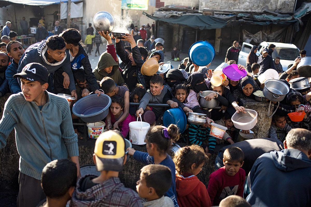 Thousands of Palestinians wait for food trucks in Rafah, March 12, 2024.