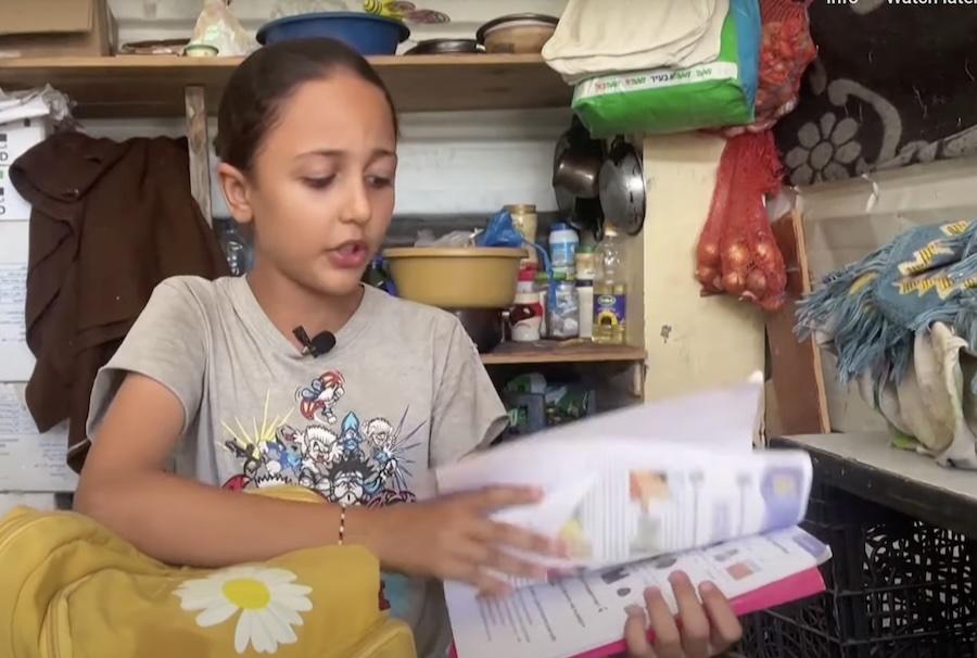 A girl in Gaza with a school book