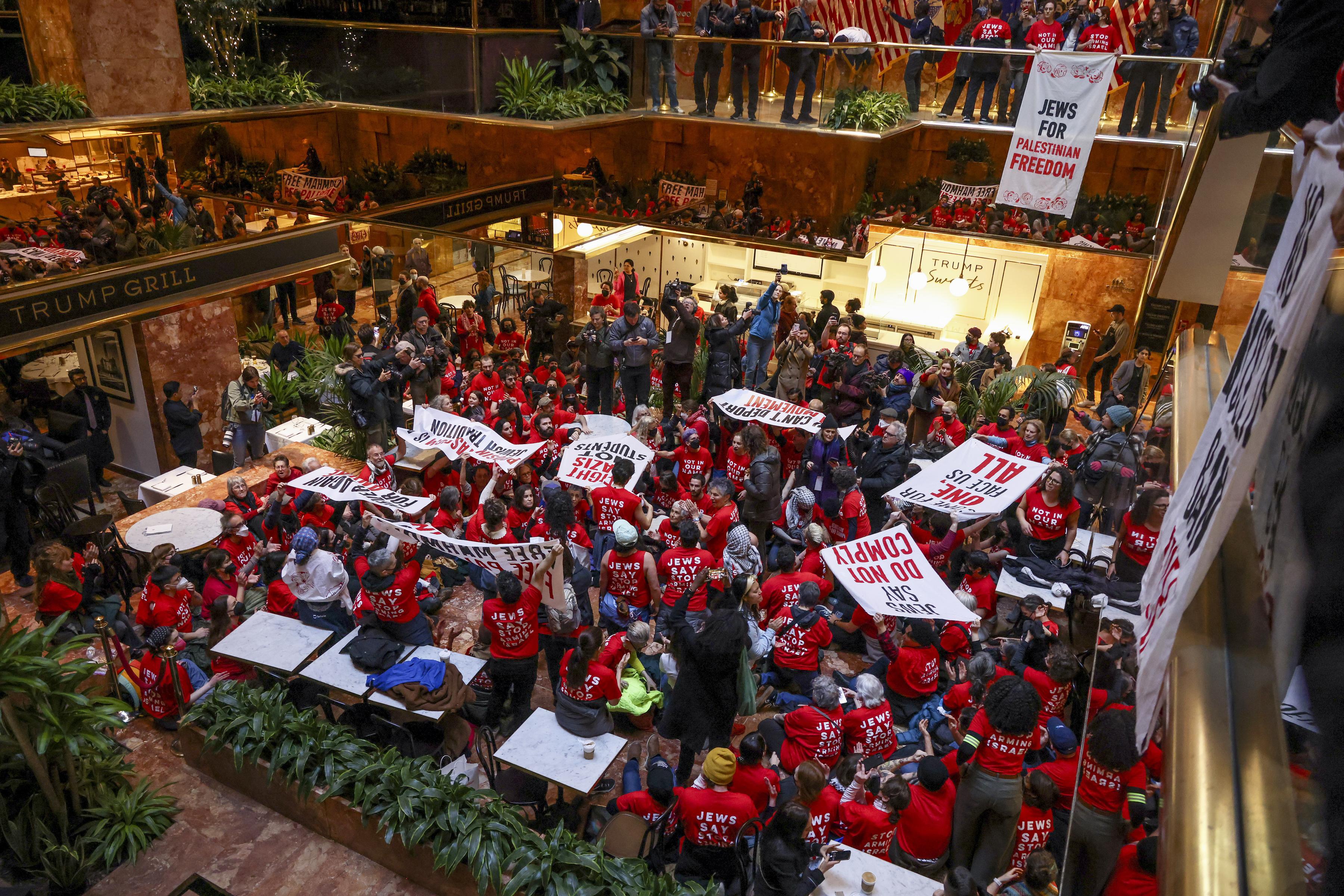 rotest for Mahmoud Khalil:  Jewish Voice for Peace in red shirts, protest inside Trump Tower, NYC, March 13, 2025.