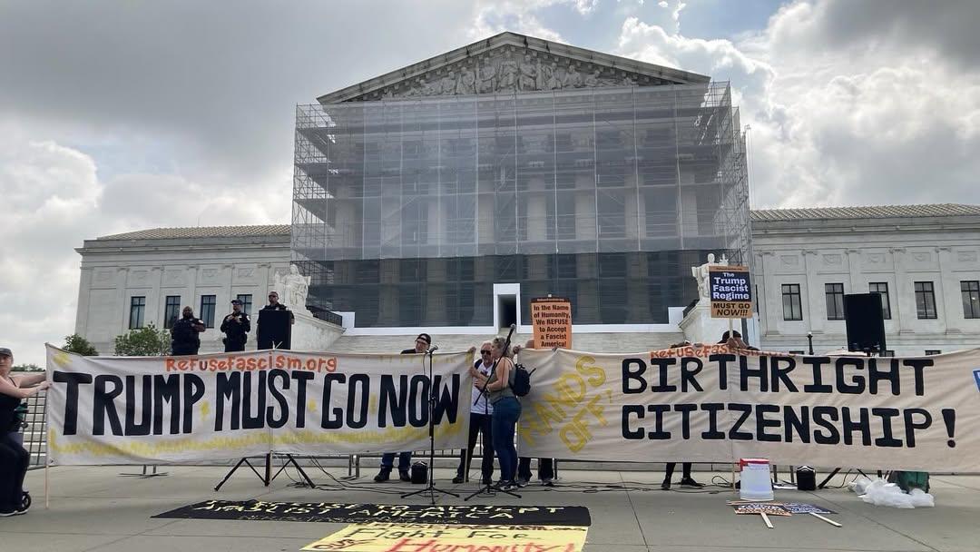 Large banners In front of Supreme Court: Trump Must Go Now! and Hands Off Birthright Citizenship!