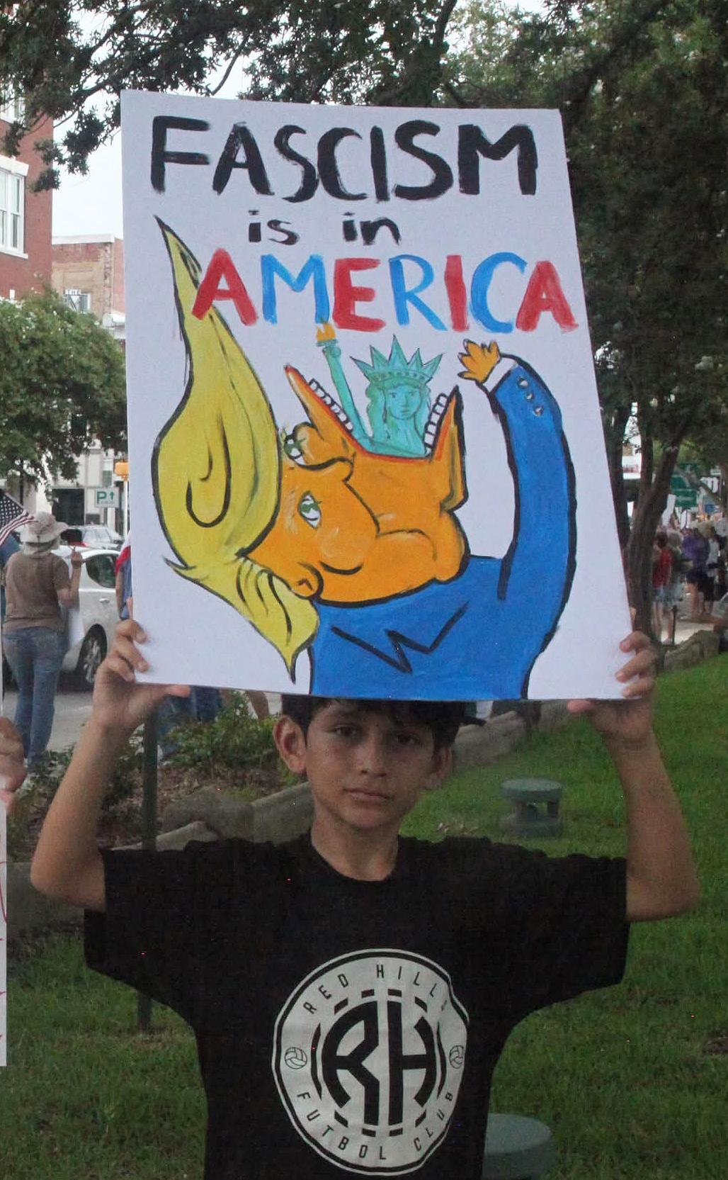 No Kings protest in Valdosta, Georgia, young boy holds up sign: "Fascism is in America"
