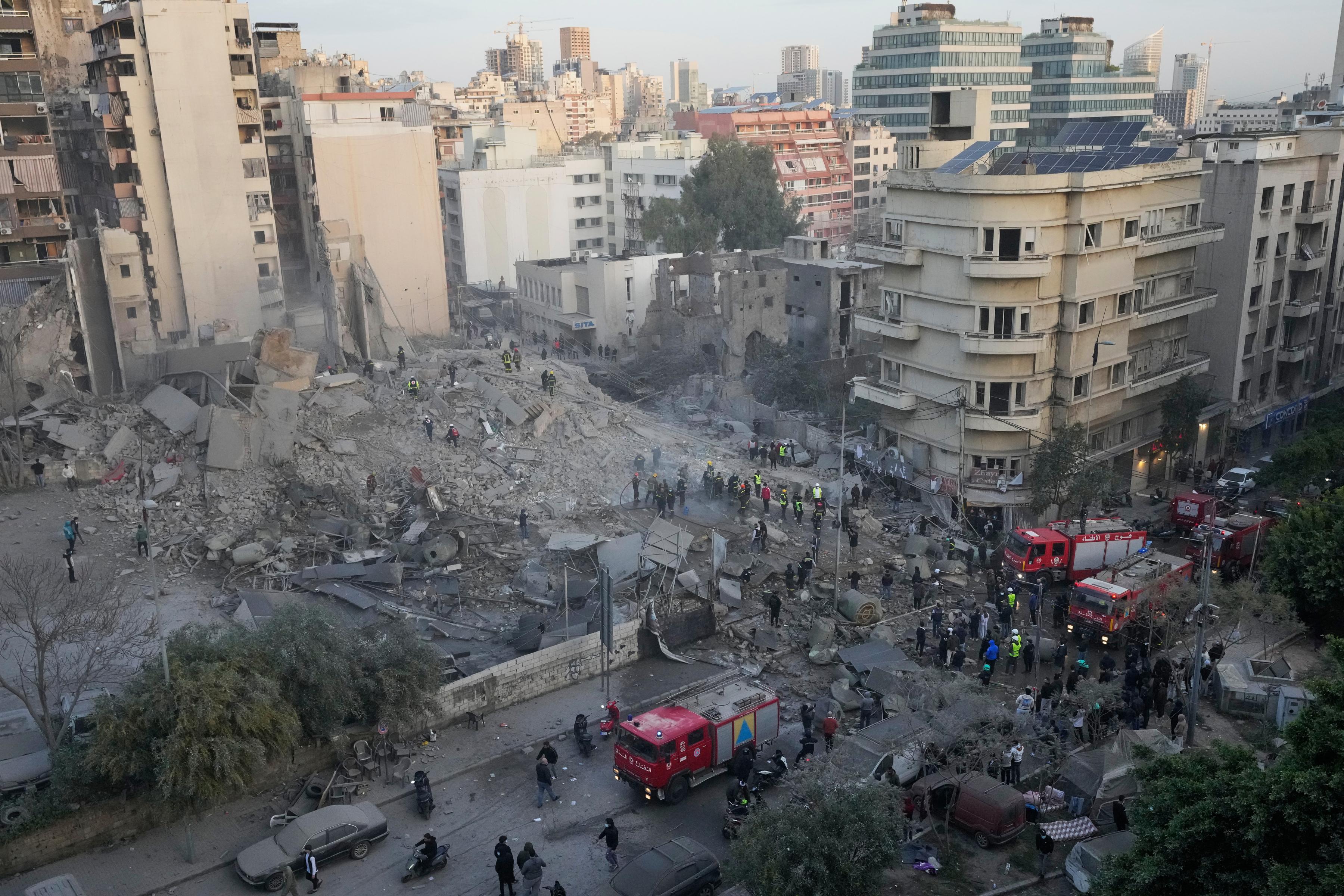 Rescue workers search through the rubble of a building destroyed in an Israeli airstrike in central Beirut, Lebanon, March 18, 2026.