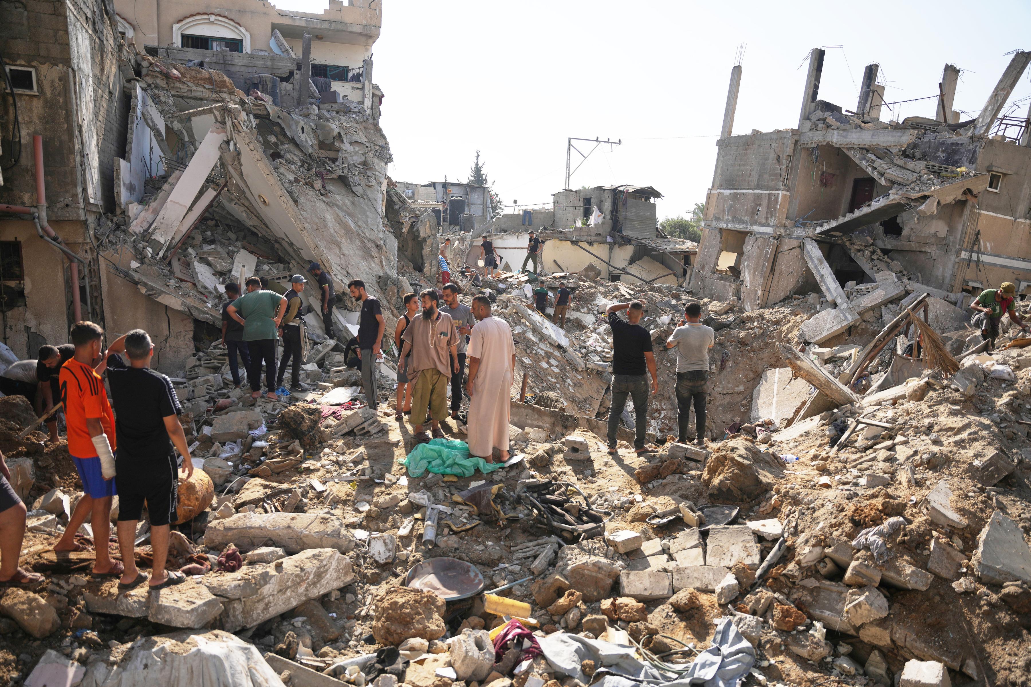 Palestinians inspect destruction from Israeli airstrike, at al-Maghazi refugee cam, Gaza, August 1, 2026.