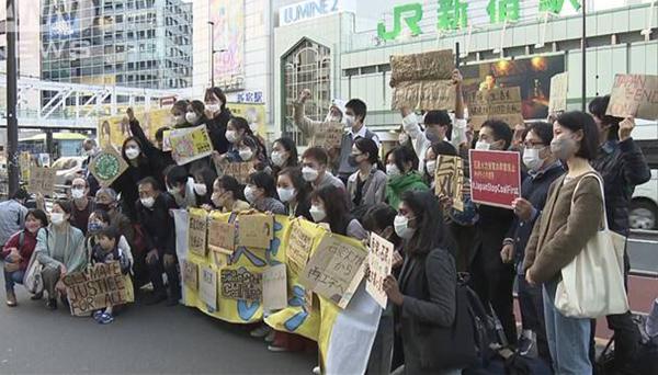 Group of Japanese hold banner and signs