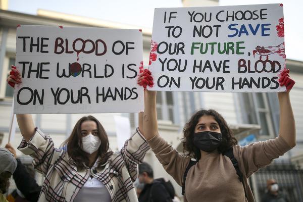 Two women hold up protest signs in Istanbul, Turkey