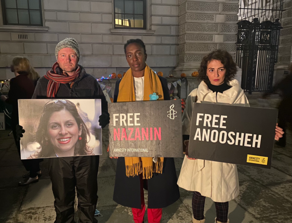 Protesters with signs supporting Iran political prisoner hunger strike.