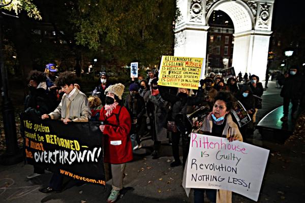 At Washington Square Park, NYC, a banner- The System Cannot Be Reformed It Must Be Overthrown - at protest of Kyle Rittenhouse's Not Guilty verdict.