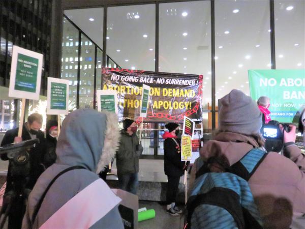 RevComs with banner battle for abortion rights.