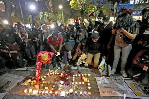 People light candles for number 55, for 55 migrants killed in Chiapas.