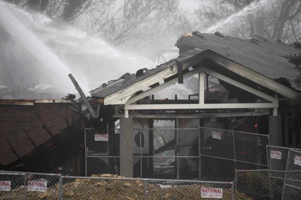 Fire hoses spray water on charred remains of Planned Parenthood clinic in Knoxille, Tennessee.