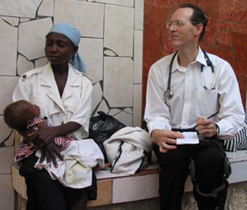 Paul Farmer with a Haitian mother and her child in 2013.