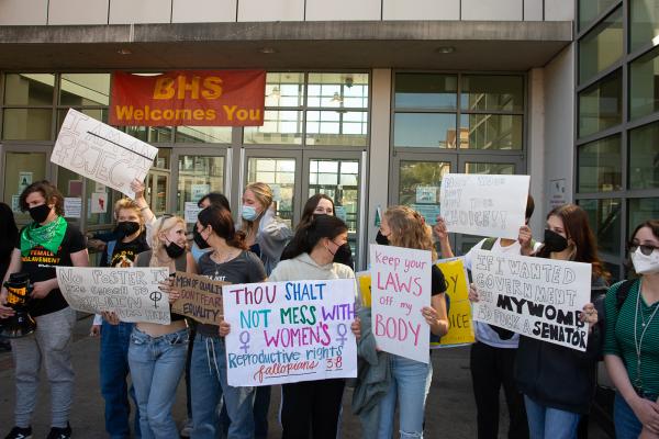 High School students with their signs get in line for IWD march.