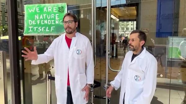 Peter Kalmus, chained to corporate doors, participates in Scientist Rebellion.
