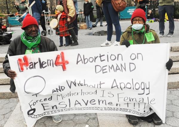 Two people hold Harlem 4 abortion on Demand sign