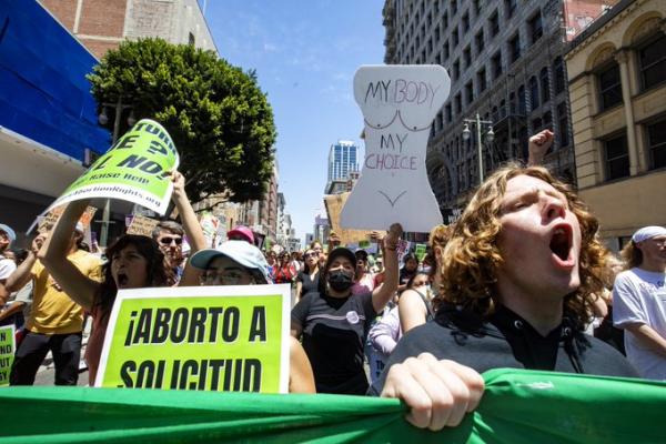 Youth lead with banner for RU4AR march in LA May 14.
