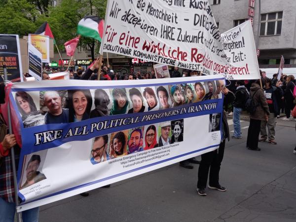 May Day 2022 Berlin - IEC banner showing political prisoners in Iran