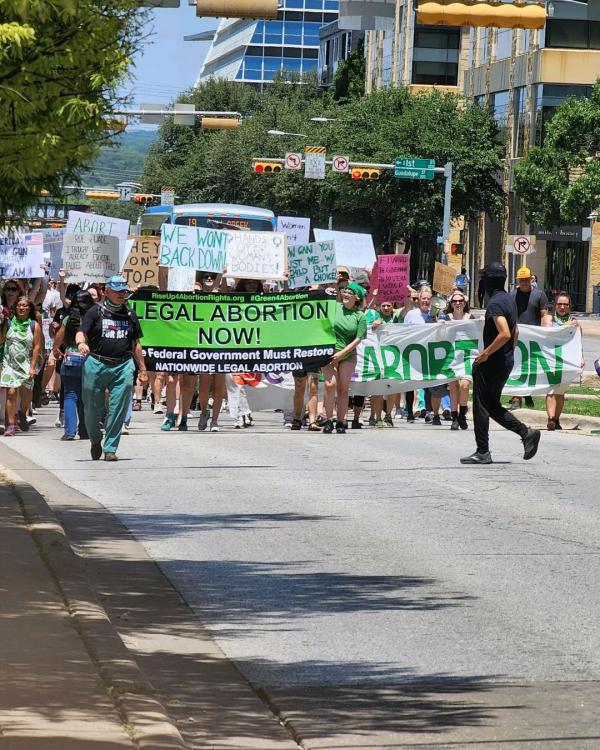 Banner Rise Up 4 Abortion Rights leads march in Austin, Texas, July 4.