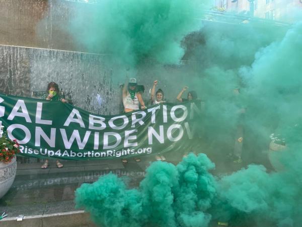 July 29, RU4AR activists protest in Seattle with green smoke.