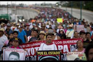43 Ayotzinapa teachers’ college students’ relatives protest their disappearance one year later.