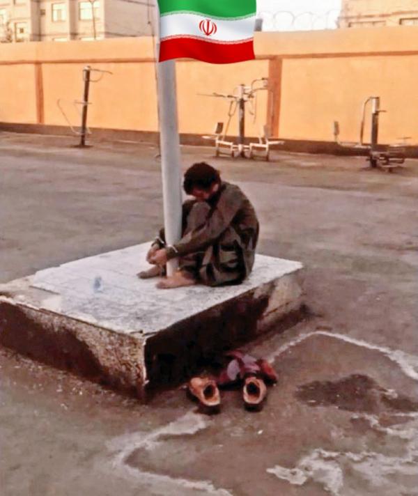 Iran, November 2022, Khodanour Lajal tortured by being handcuffed to a pole.