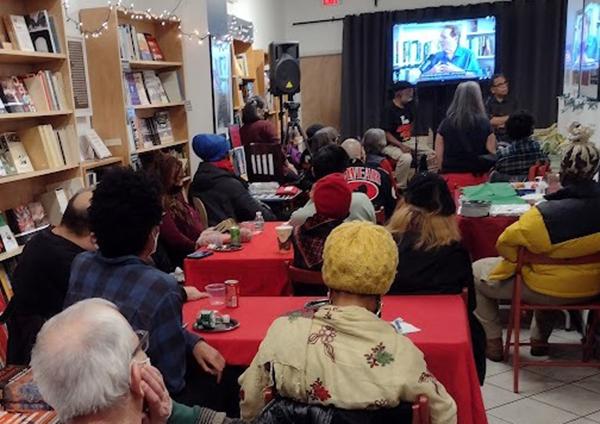 Revolution Books NYC, watching BA interview at Holiday Open House.