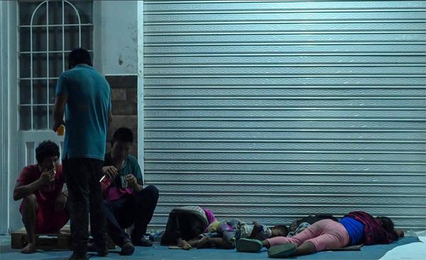 Indigenous children and adults sleeping on a street in San José del Guaviare, Colombia.