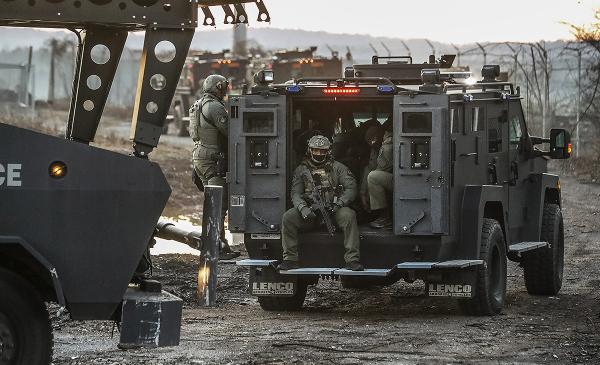 Cops ride tank on contested construction site of Atlanta Cop City.