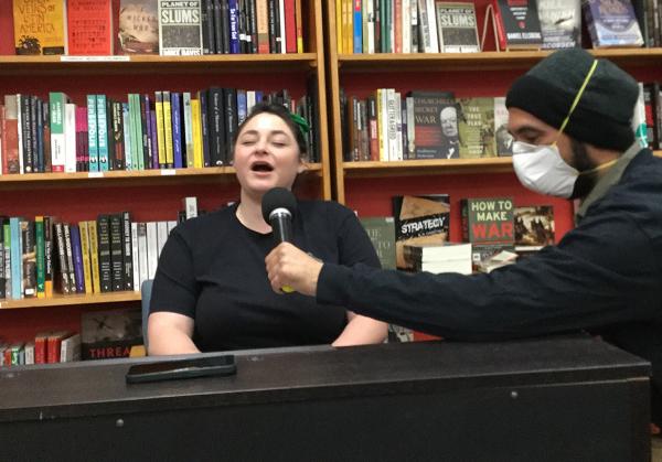 Young woman sings at the Bay Area IWD celebration, March 8, 2023.